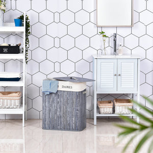 Bamboe wasmand 100L luxe wassorteerder met 2 compartimenten grijs in een moderne badkamer setting