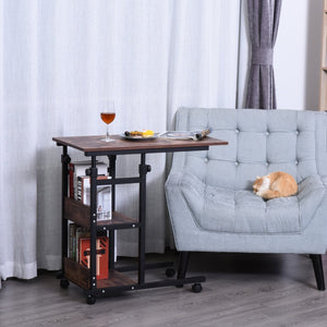 Zwarte verrijdbare salontafel met verstelbare hoogte en opbergruimte voor boeken en accessoires naast een grijze stoel